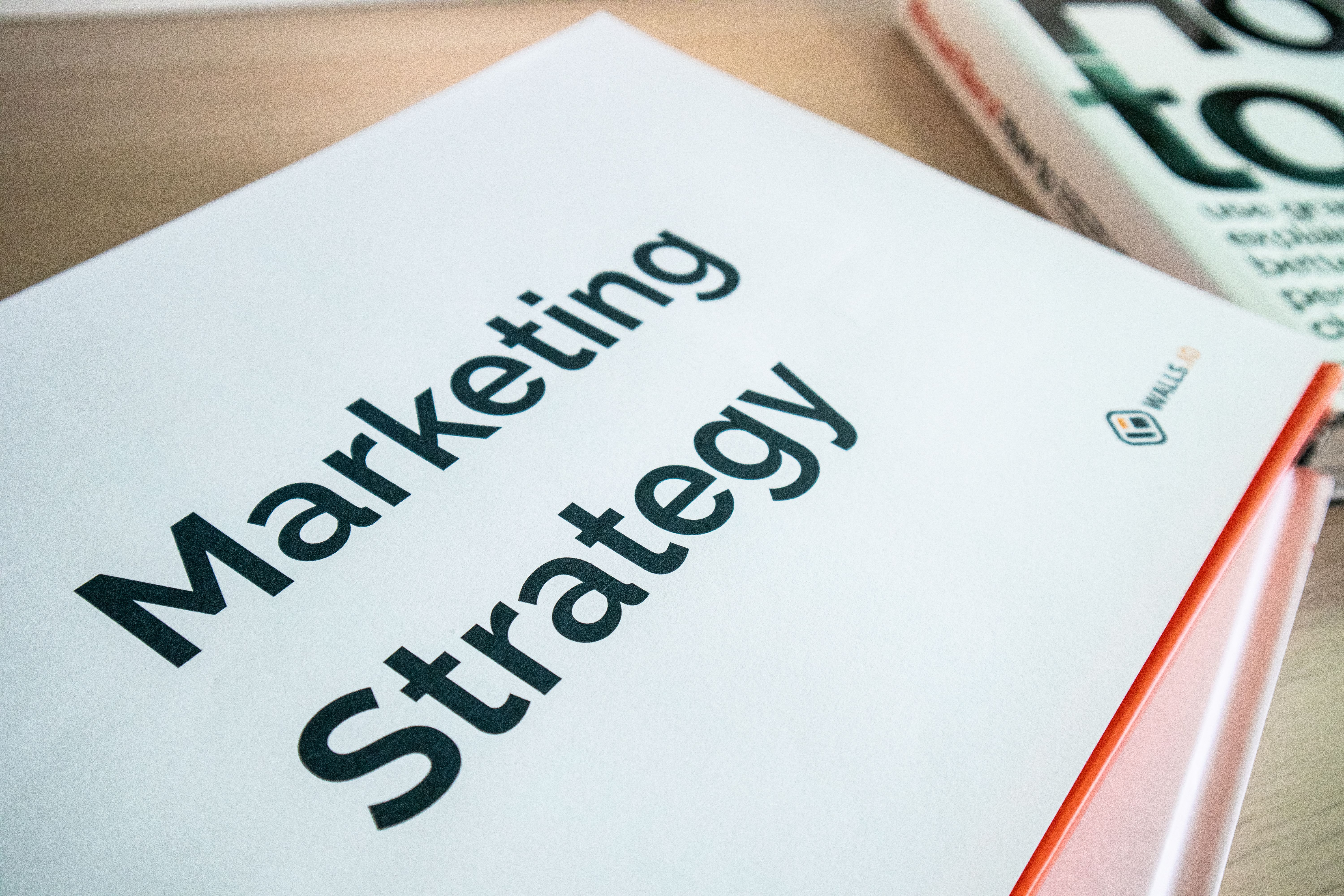 Page titled Marketing Strategy on top of a stack of folders and pages